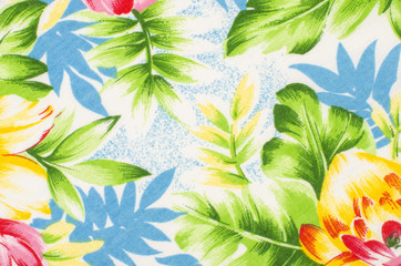 Naklejka premium Floral pattern on fabric. Green and blue leaves print as background.