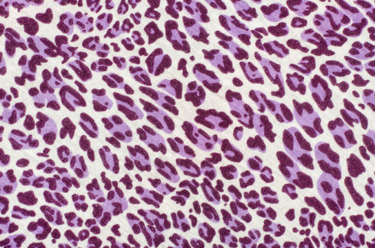 Purple leopard fur pattern. Spotted animal print as background.