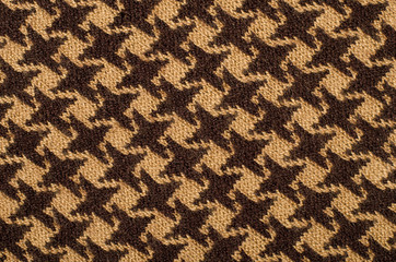 Close uo on brown houndstooth wool pattern. Dogstooth check design as background.