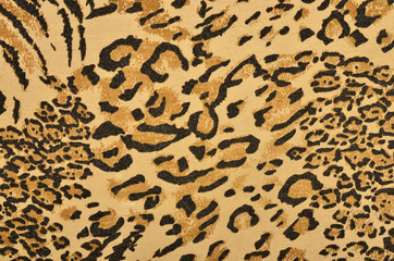 Brown leopard fur pattern. Spotted animal print as background.