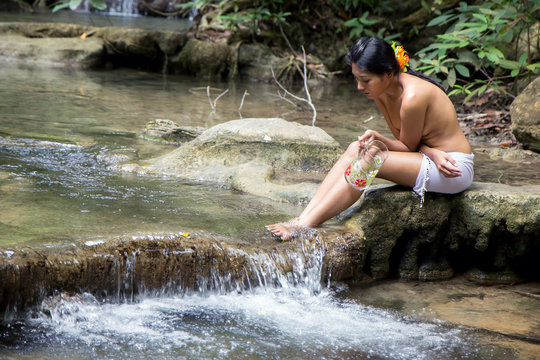 girl with jar sitting by the creek