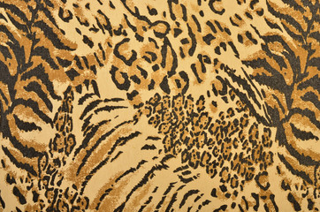 Brown and black leopard and tiger fur pattern.  Spotted and striped animal print as background.