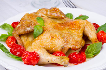 Whole roast chicken with tomatoes cherry, green basil and garlic
