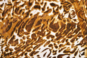 Brown leopard fur pattern. Spotted animal print as background.