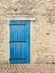 Fototapeta na wymiar Old blue wooden door in antique building for backdrops or background