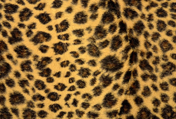 Brown leopard fur pattern. Spotted animal print as background.