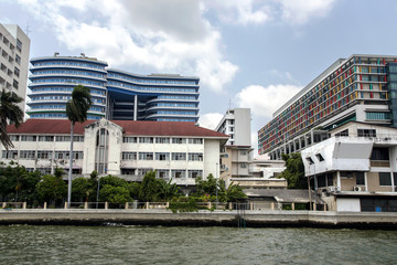 Naklejka premium View from the Chao Phraya river on modern multistory building and garden in Bangkok, Thailand