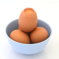 Egg in light blue cup on white background