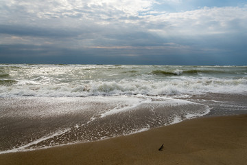 The sun's rays passing through the storm clouds over the sea