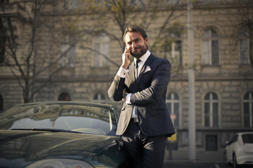 Elegantly dressed businessman doing a phone call