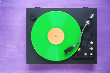 Retro turntable with green vinyl record, free copy space