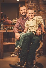 Stylish little boy and his father in a barber shop © Nejron Photo