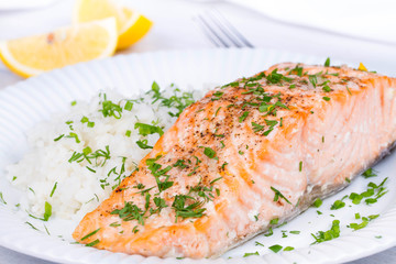 Steamed salmon with fresh herbs and lemon. Rice as a garnish