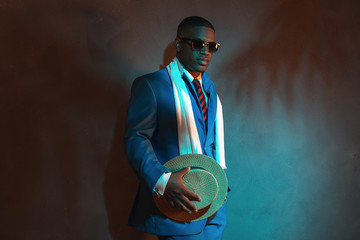 Retro african american man in blue suit wearing sunglasses. Lean