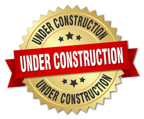 under construction 3d gold badge with red ribbon