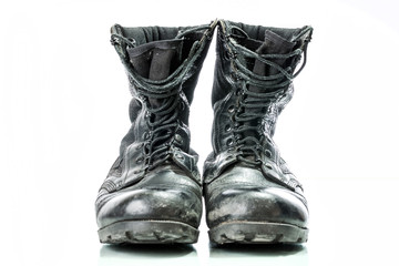 Black old combat military boots isolated on white background