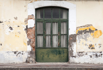 Dark green wooden door in old building facade
