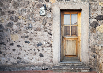 Fototapeta na wymiar Ancient wooden door with street lamp