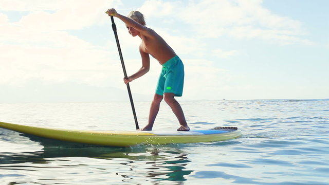 Stand Up Paddling in Hawaii. Cute Young Blonde Boys Brothers Paddling Surfboard Together.