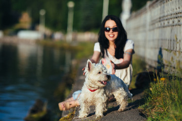 girl with a dog on the shore