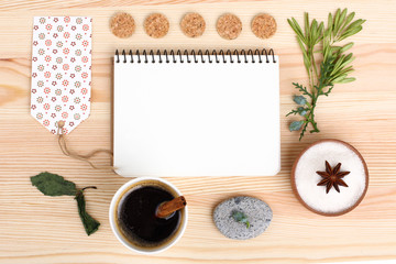 notebook and flowers on wooden background
