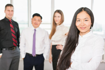 Successful asian business woman with business team