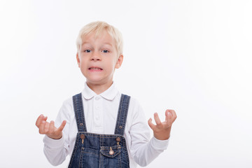 Cheerful small boy is expressing his negative emotions
