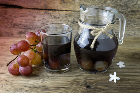 grape compote in a jar on a wooden table