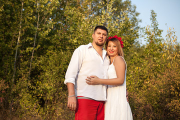 husband and wife hugging in the park outdoors