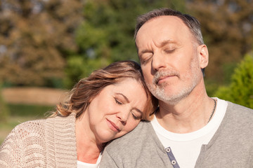 Cheerful old married couple is sleeping in the nature