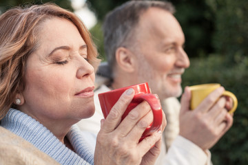 Pretty mature husband and wife are resting in park
