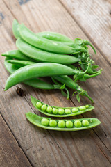 Snow peas on wood background.