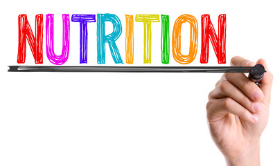 Hand with marker writing the word Nutrition