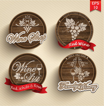 four labels for wine on wooden casks with red ribbons.