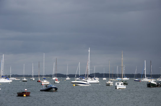Yachts anchored in the bay before the storm in sunset light. Northern Ireland.