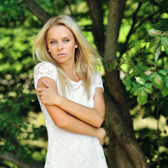 Young sensual girl posing in summer green park