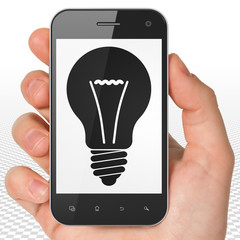 Business concept: Hand Holding Smartphone with Light Bulb