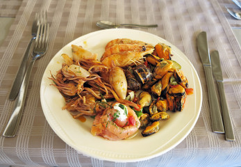 Raw Mixed seafood shrimps, octopus and mussels on dish