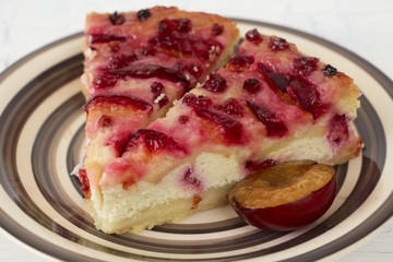 Plum cheesecake pieces and half a plum