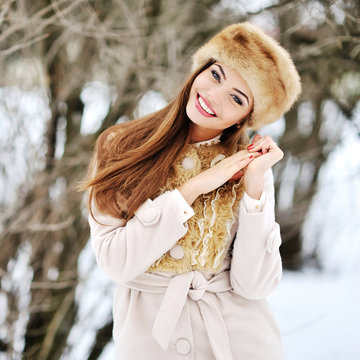 Portrait of young beautiful smiling woman in winter