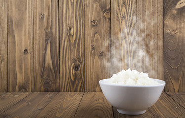 Hot Steamed Rice in a White Bowl on wooden background
