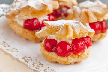 Cream Puffs with strawberries, selective focus