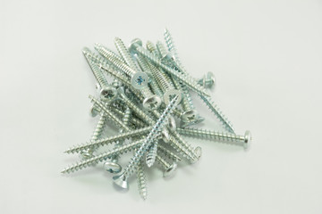 Silver screws located on a white background isolated