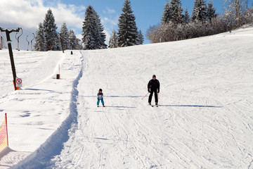 Portrait of young man, skiing in mountain winter resort, daytime