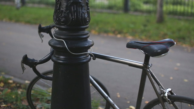 man puts the lock on the bike