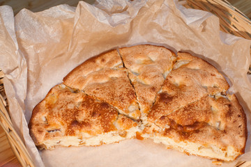 Sliced apple pie on baking paper