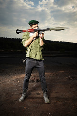 Man with RPG bazooka posing on dark field