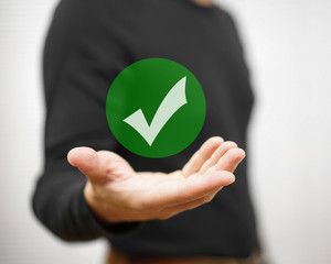 Businessman showing green check mark. Concept of correct decisio