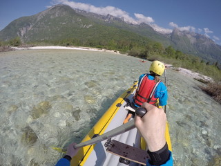 Paddling on wild river, sight from canoe on whitewater