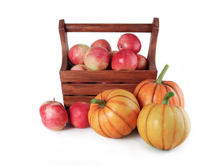 ripe apples in a box and beautiful pumpkin on a white background